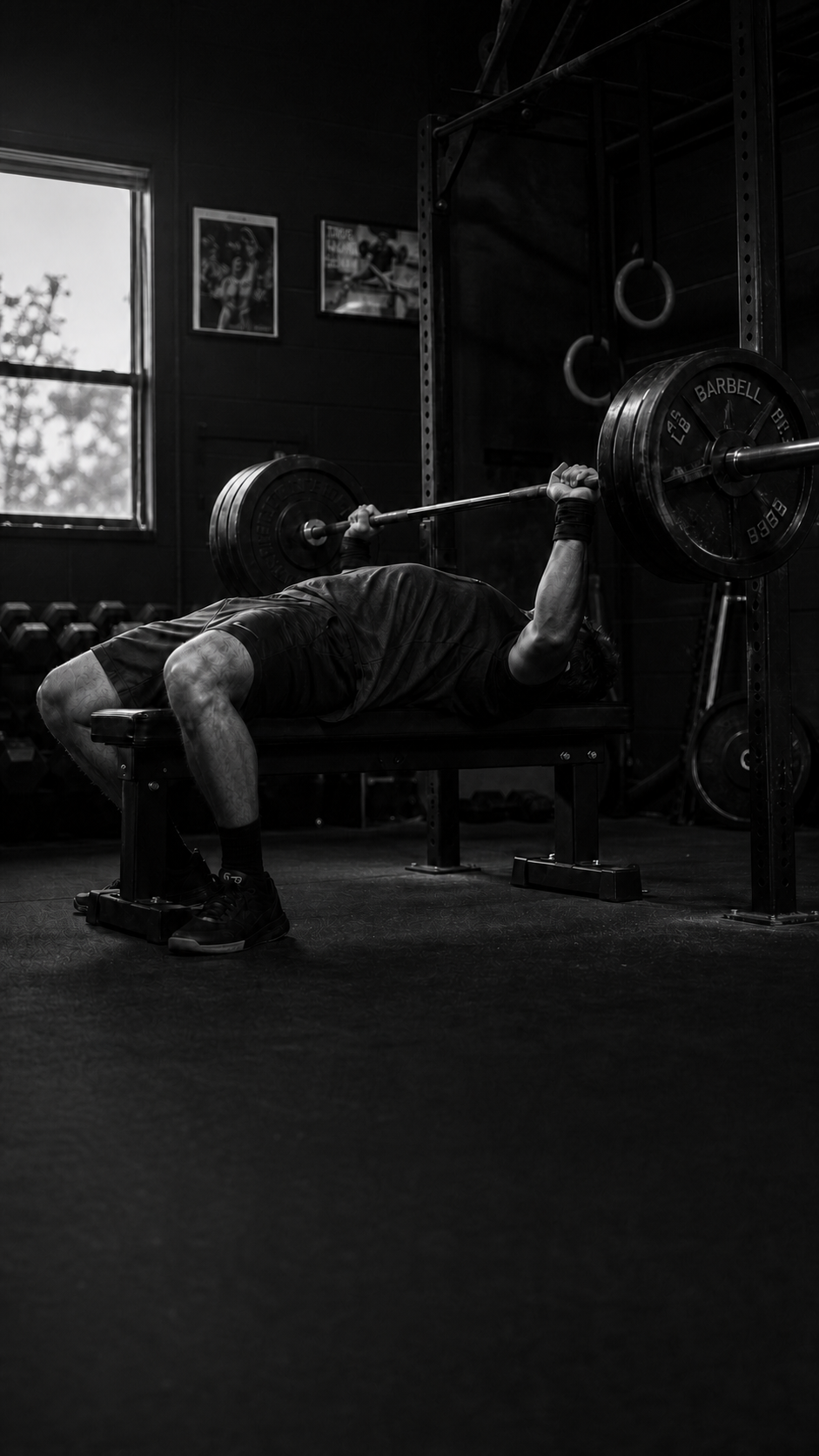 An athlete training with a barbell in a quiet gym